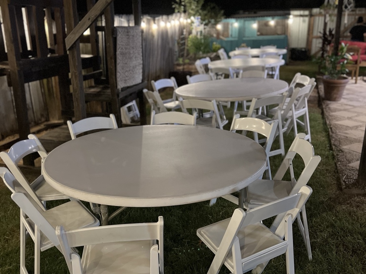 Round tables with white resin chairs