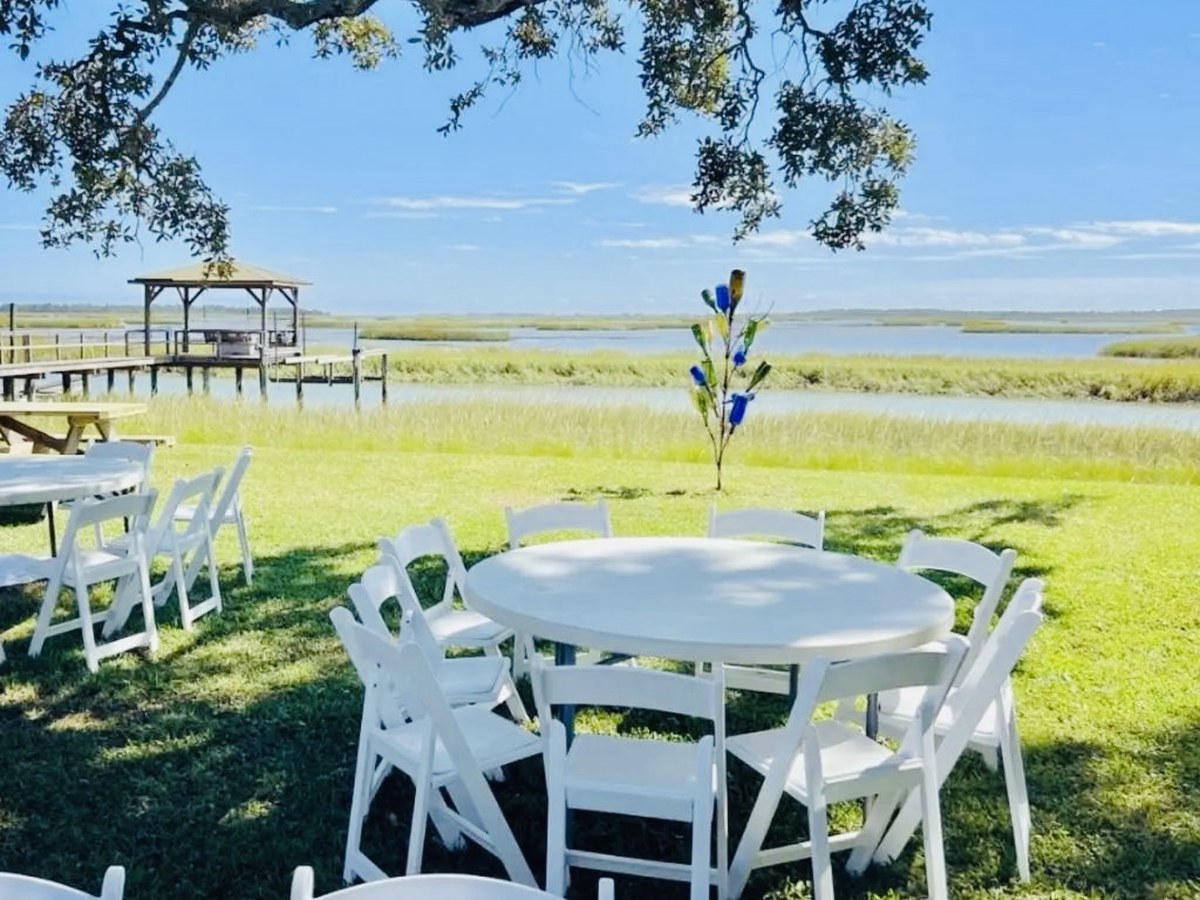 Outdoor round table and white chair event setup