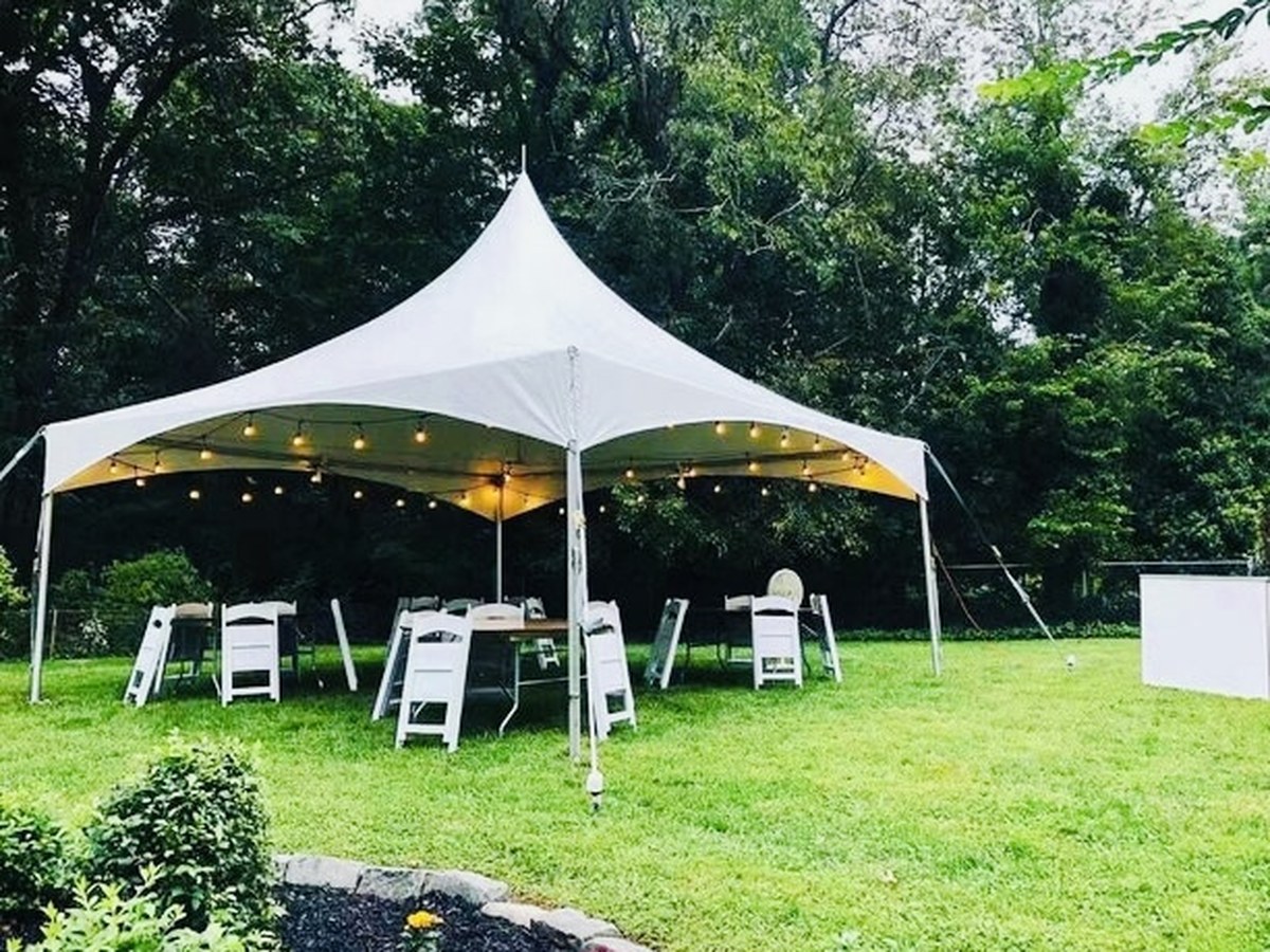 White High Peak tent with event lighting and seating