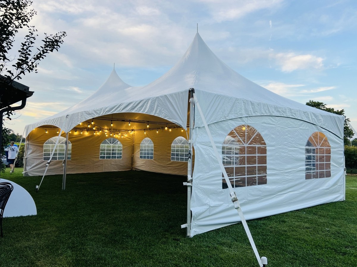 Enclosed white event tent with warm lighting