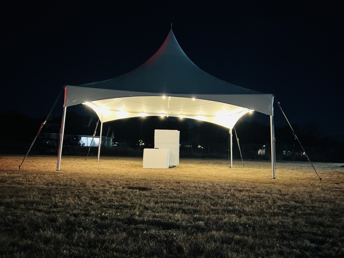 Illuminated High Peak tent at an evening event