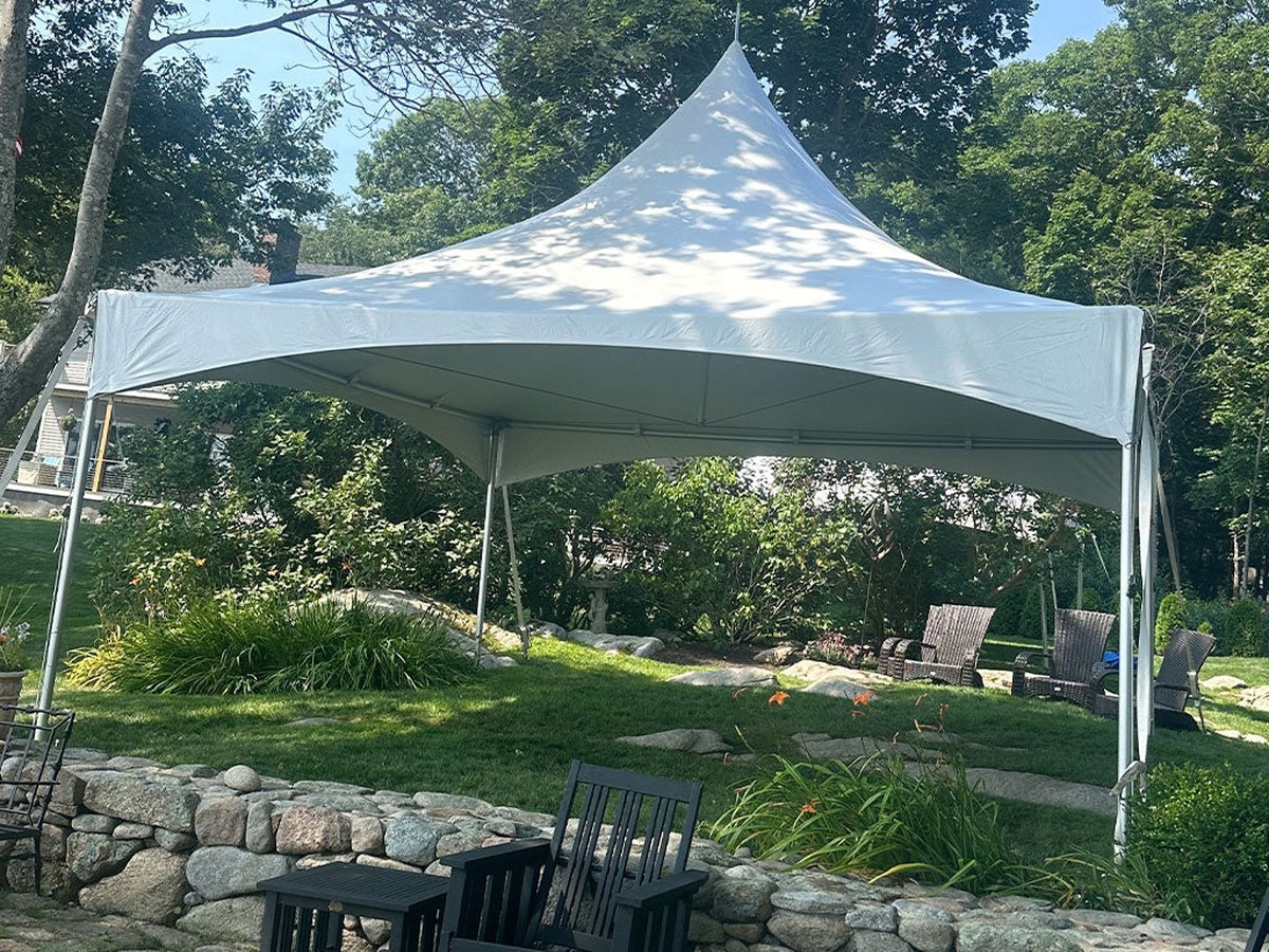 White High Peak tent in a landscaped outdoor setting
